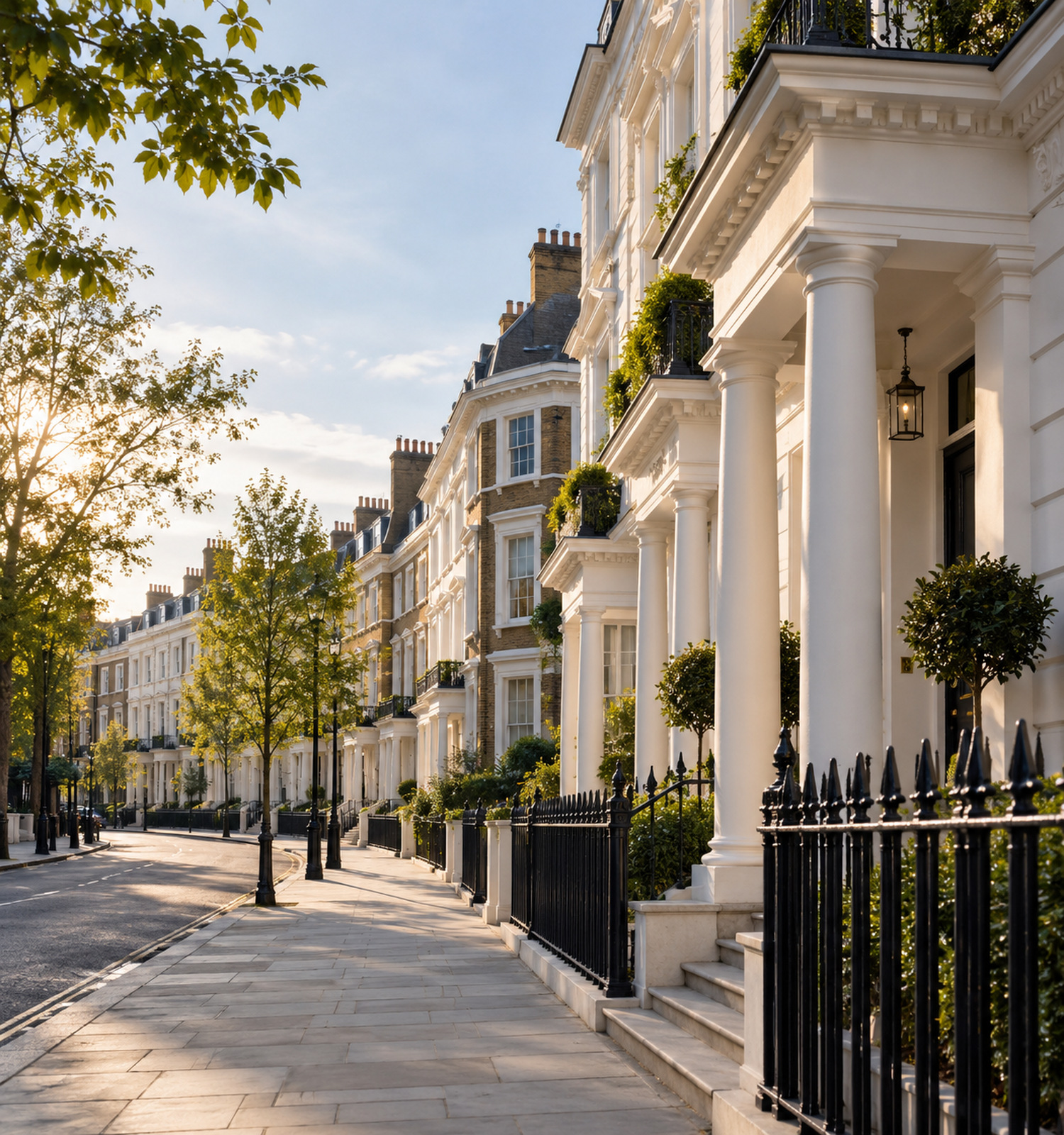A sunlit street of white stucco townhouses in London